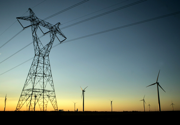 High-voltage electric transmission lines pass through a wind farm in Spearville, Kansas.