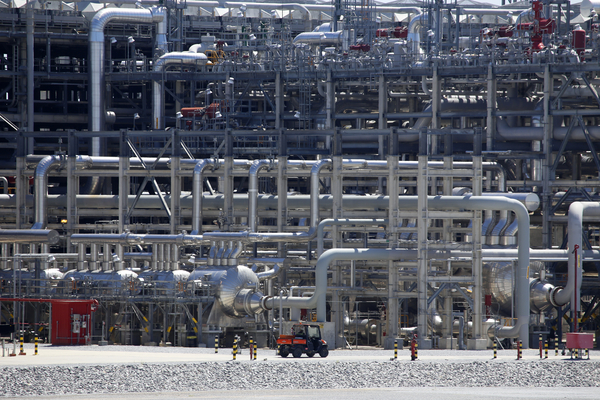 A small vehicle drives past a network of piping that makes up pieces of a "train" at Cameron LNG export facility in Hackberry, La., on Thursday, March 31, 2022. 