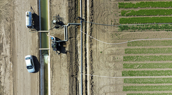 Irrigation pumps on a canal run through agriculture fields in Holtville, California.