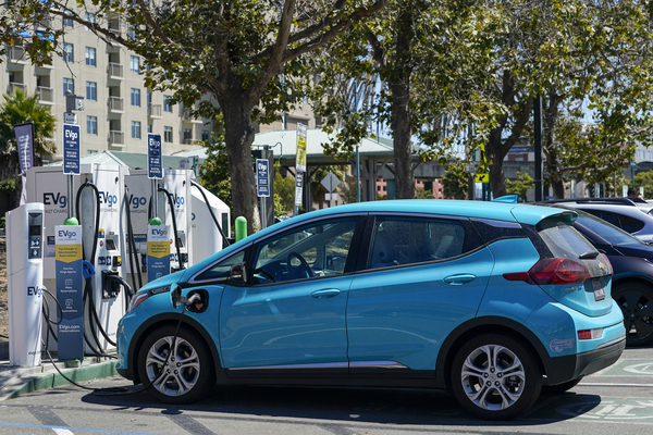 Electric vehicles recharge at a shopping center.