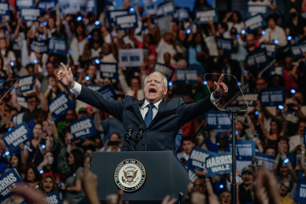 Tim Walz gestures as he speaks during a campaign rally.