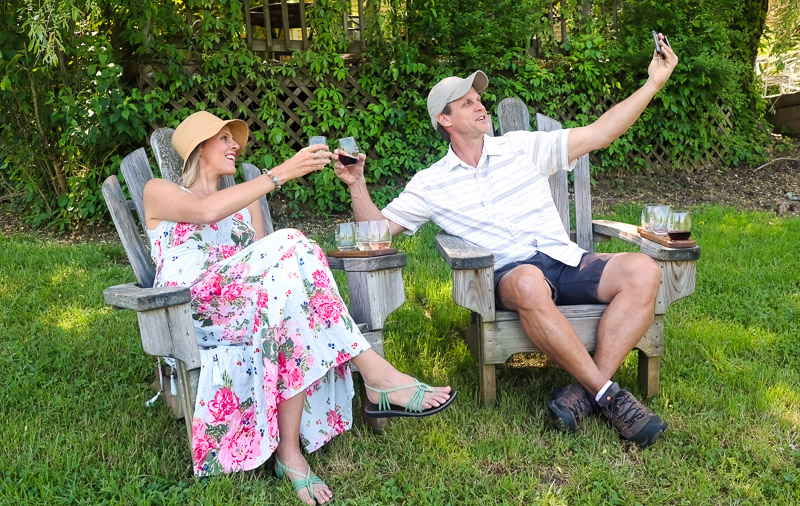 people sitting on lawn chairs holding wine