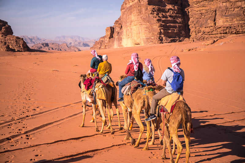 riding a camel in wadi rum