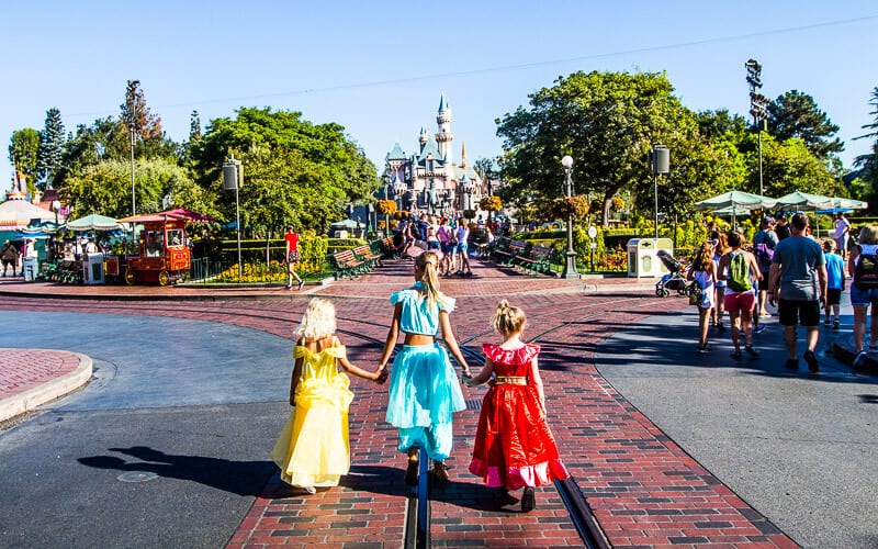 three children Walking along Main Street U.S.A. in Disneyland