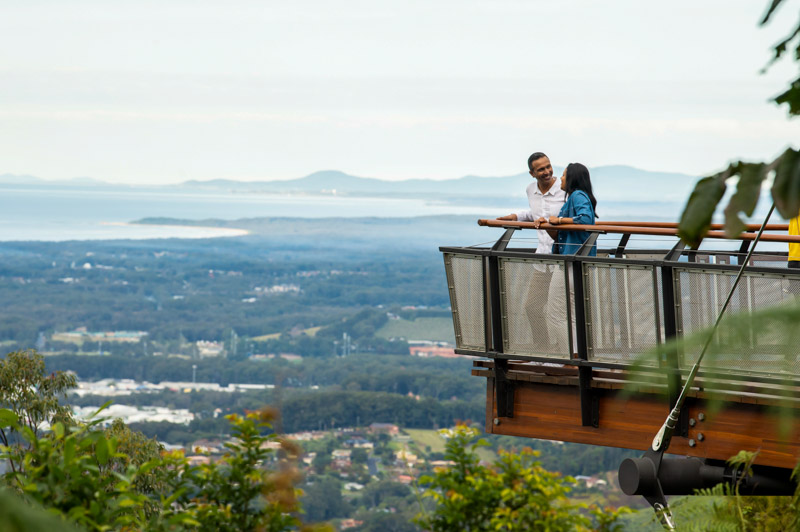 Couple enjoying scenic views over Coffs Harbour from Forest Sky Pier, Niigi Niigi - Sealy Lookout, Coffs Harbour.
