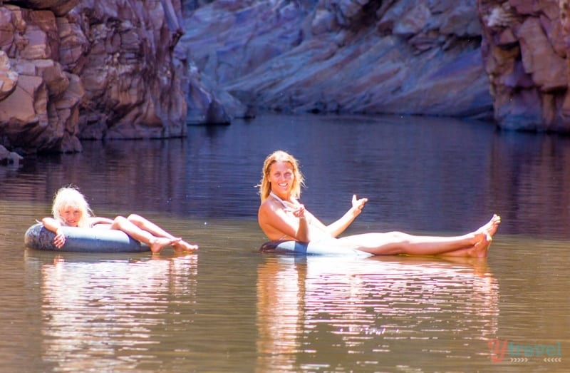 girls on tube floating on canyon river