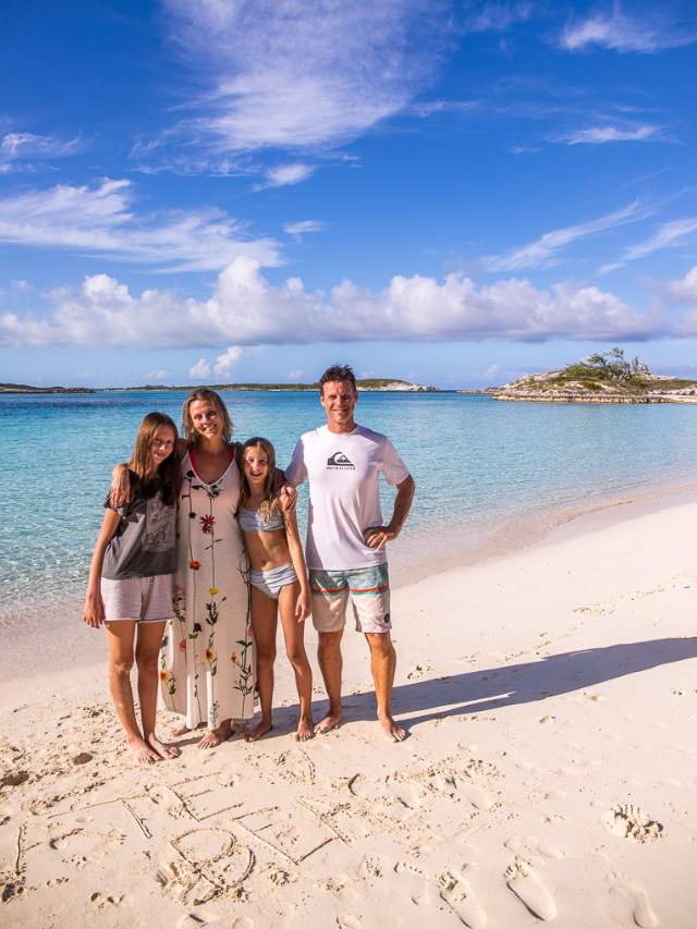 family posing on exuma island beach